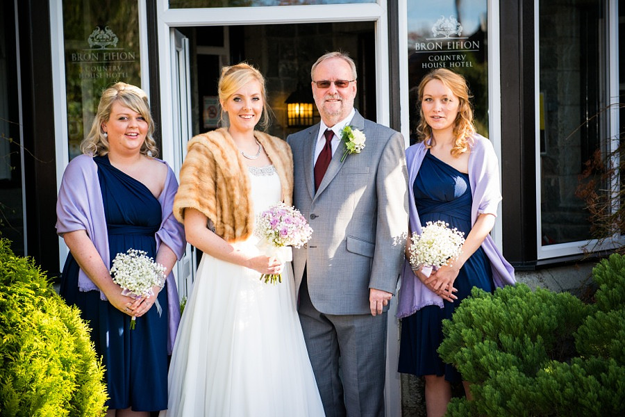 Bride, father of the bride and bridesmaids group shot by North Wales Wedding Photographer Celynnen Photography