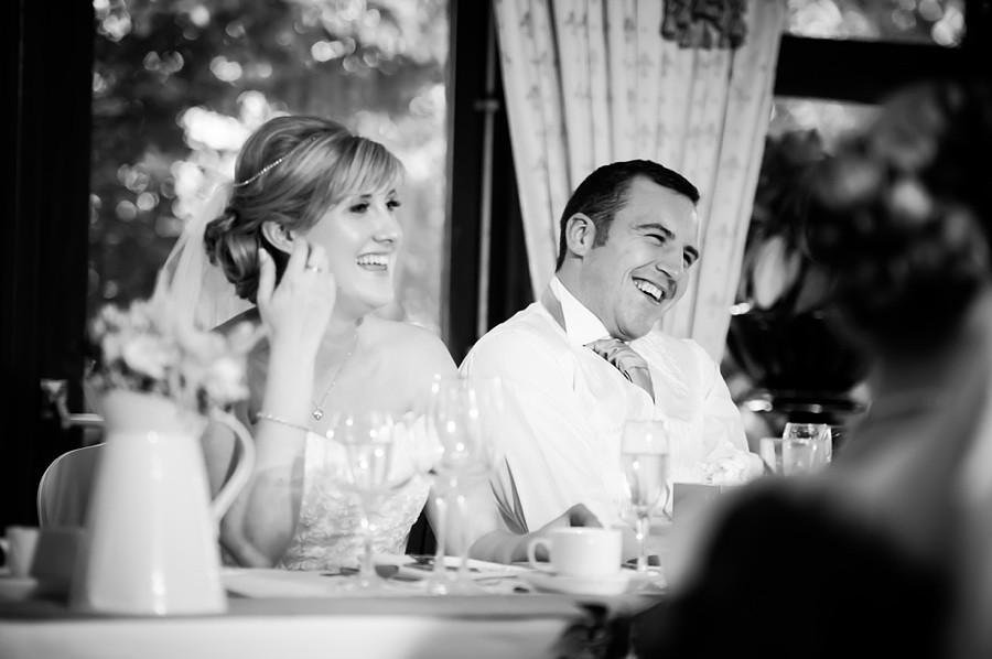 Bride and Groom laughing at Wedding Reception by North Wales Wedding Photographer Celynnen Photography