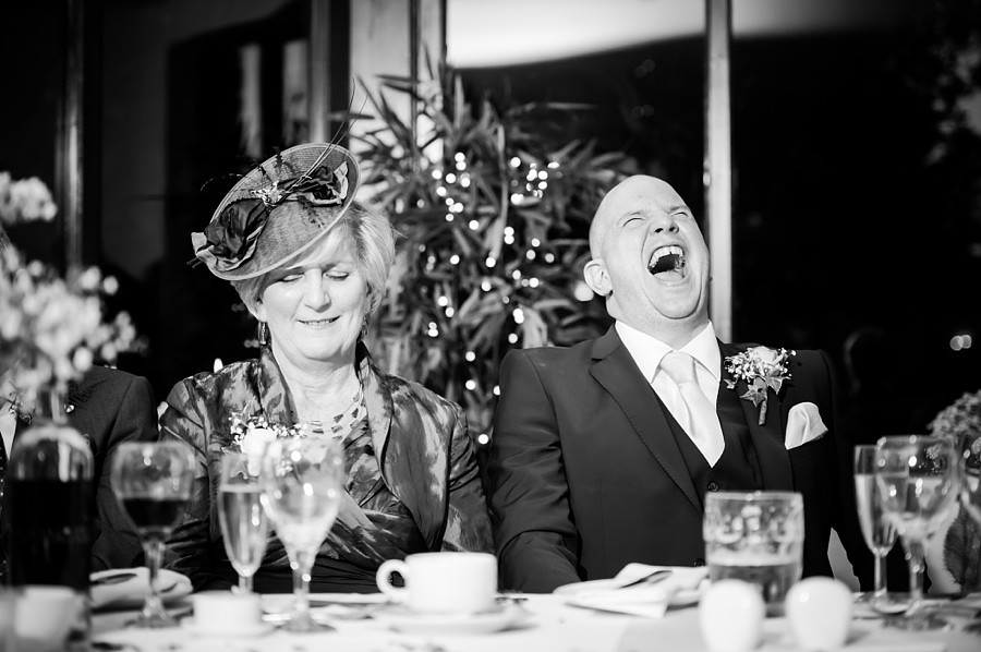 Groom laughing during speeches by North Wales Wedding Photographer Celynnen Photography