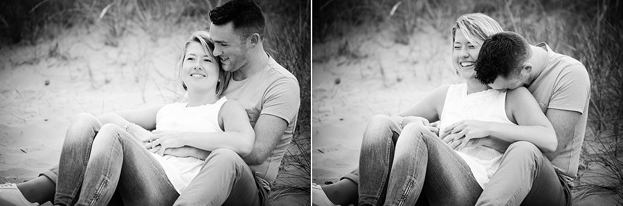 couple talking and laughing, sat on the dunes of talacre beach in North Wales, by Mold, for their portrait photography session