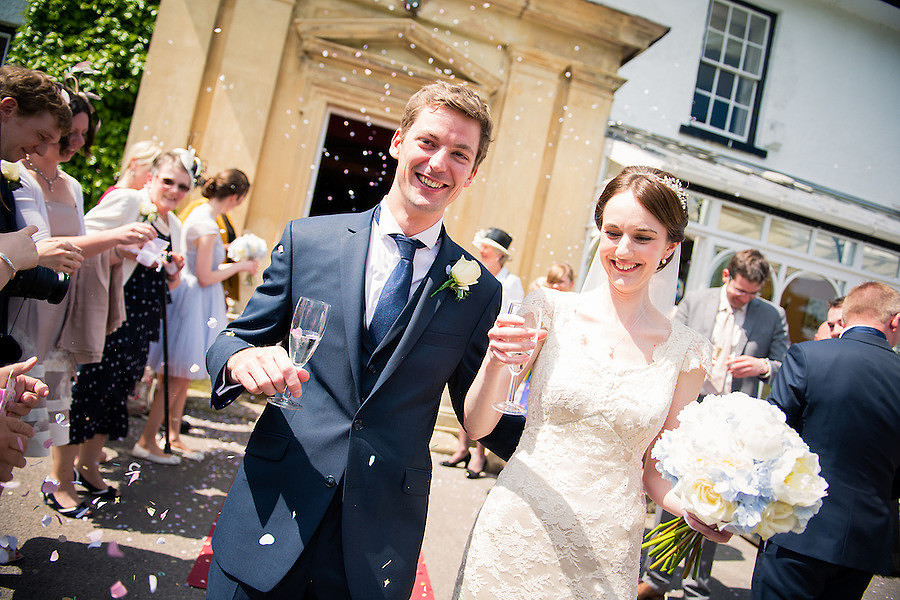 Bride and groom after being showered with confetti at Plas Hafod.