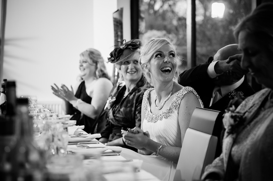 Bride laughing during speeches by North Wales Wedding Photographer Celynnen Photography