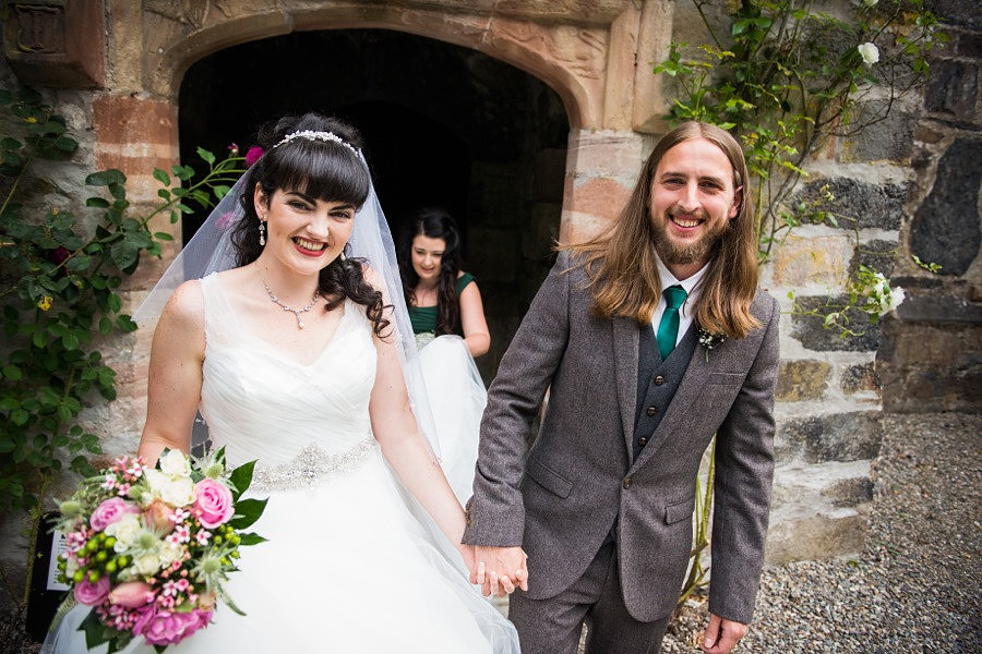 Bride and groom coming out of the wedding ceremony at Gwydir Castle. North Wales Wedding photographer, Celynnen Photography