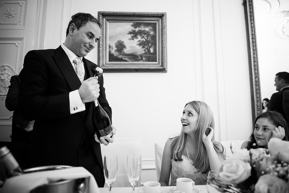 Black and white image of the bride and groom during the groom's speech at a wedding at Taplow House, Buckinghamshire.