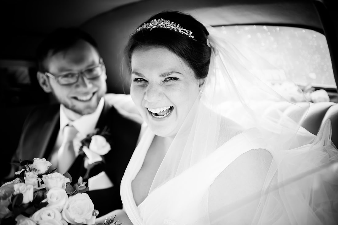 Black and white image of a happy bride after their wedding ceremony.