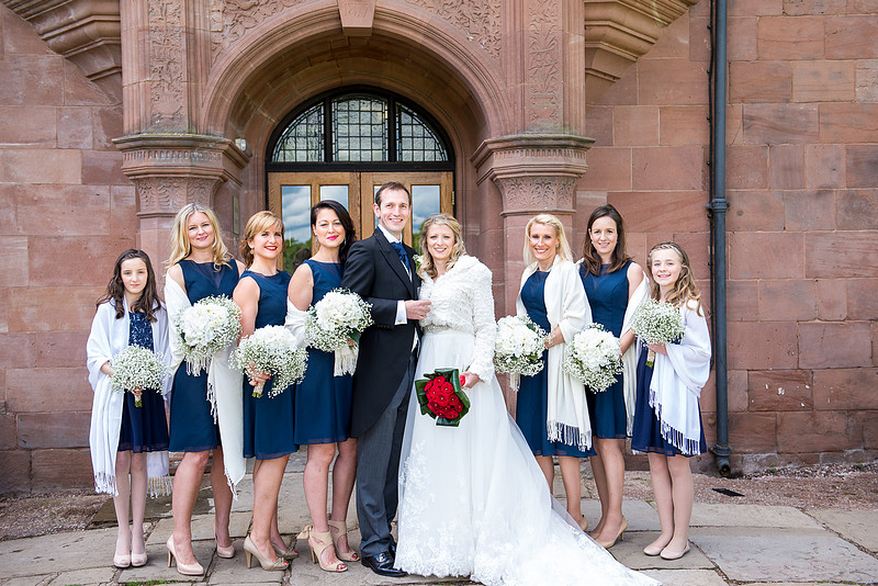 Portrait of the bride and groom and all of the bridesmaids at a wedding in Davenham, Cheshire.