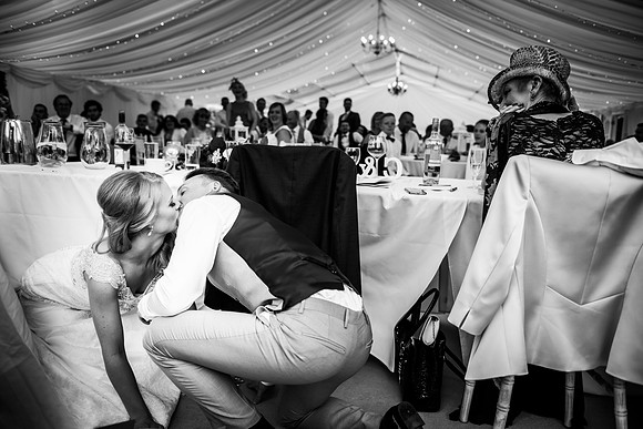 bride and groom kissing in the marquee at their wedding at Bodrhyddan Hall