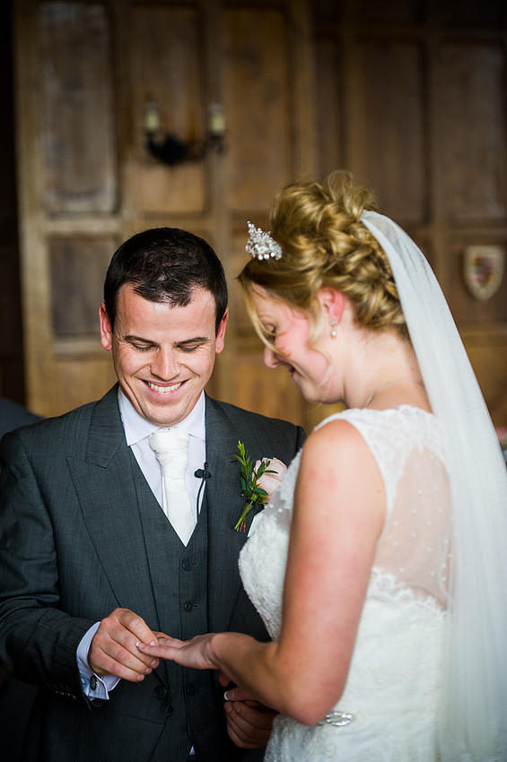 The bride and groom exchanging their rings at their wedding at Chateaux Rhianfa, Anglesey. Wedding Photographer, Celynnen Photography