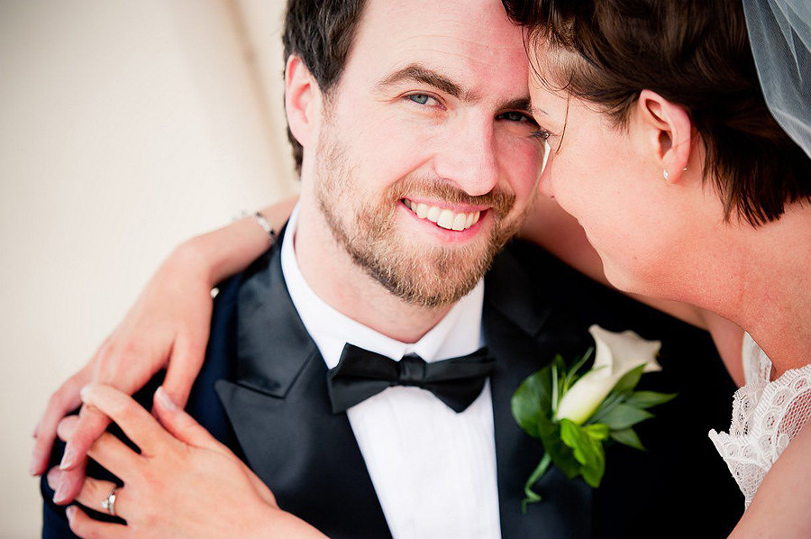 bride and groom on llandudno beach near the st-georges hotel by Celynnen Photography