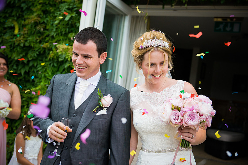 Bride and groom getting showered with confetti at their Wedding at Chateaux Rhianfa, Anglesey. Wedding Photographer, Celynnen Photography