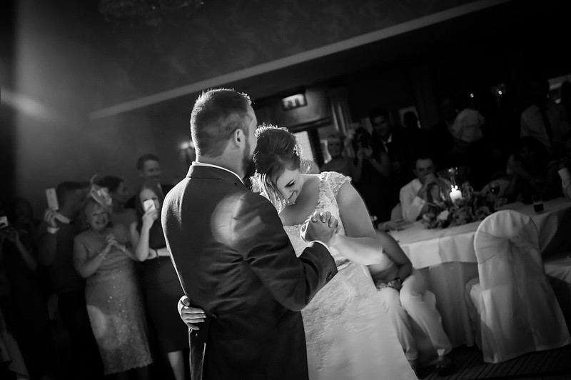 Black and white image of the bride and groom having their first dance at Rowton Hall.