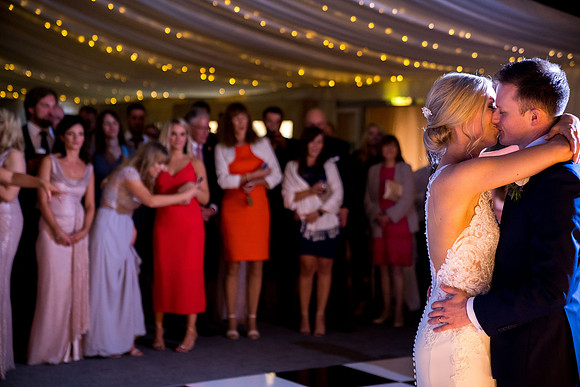 Audience Looking Satisfied While the Wedding Pair is Sharing a Romantic Moment