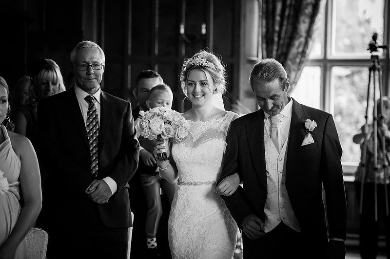 The bride walking down the aisle. Wedding at Chateaux Rhianfa, Anglesey. Wedding Photographer, Celynnen Photography