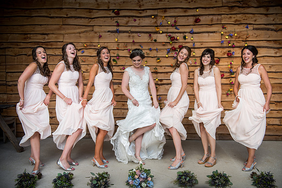 Bride and Bridesmaids having some fun at Tower Hill Barns near Llangollen, captured by Celynnen Photography