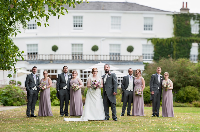 Portrait of the bridal party outside of Rowton Hall.