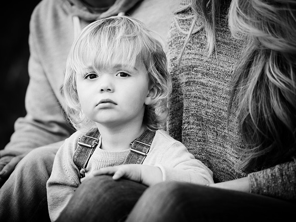 Black and white portrait of a young boy with his parents on a family photoshoot in North Wales