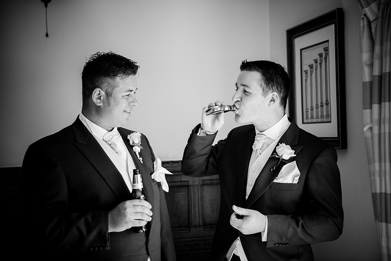 The groom and his brother having a drink before wedding in Chateaux Rhianfa, Anglesey. Wedding Photographer, Celynnen Photography