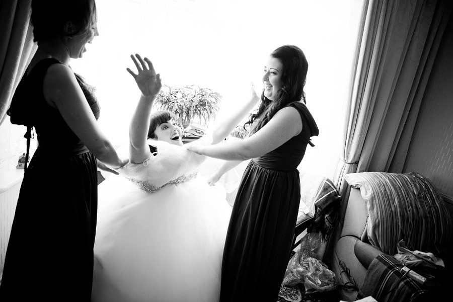 Bride in llandudno get her dress on before her wedding at Gwydir Castle, Conwy. North Wales Wedding photographer, Celynnen Photography