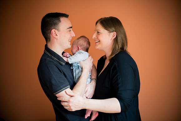 Parents cuddling their baby while enjoying a portrait photoshoot by Celynnen Photography in Ruthin