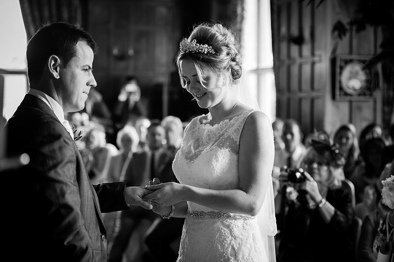Bride and groom exchanging rings. Wedding at Chateaux Rhianfa, Anglesey. Wedding Photographer, Celynnen Photography