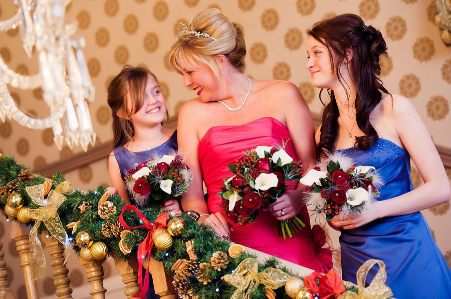 Bride and her bridesmaids in the stairs with the chandelier at the Chester Grosvenor