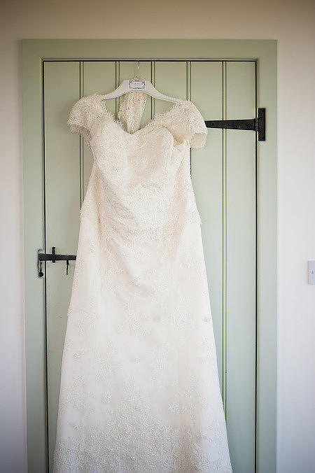 Bride's wedding dress hanging up for a wedding in Anglesey.