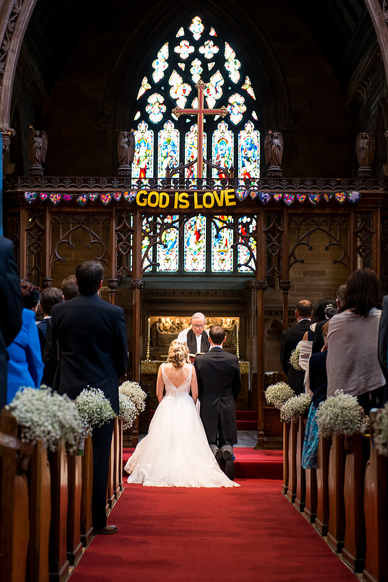 Photo from the back of a church during a wedding ceremony in Davenham, Cheshire.