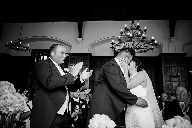 Black and white image of the bride and groom kissing at a wedding in Chateaux Rhianfa, Anglesey. Wedding Photographer, Celynnen Photography