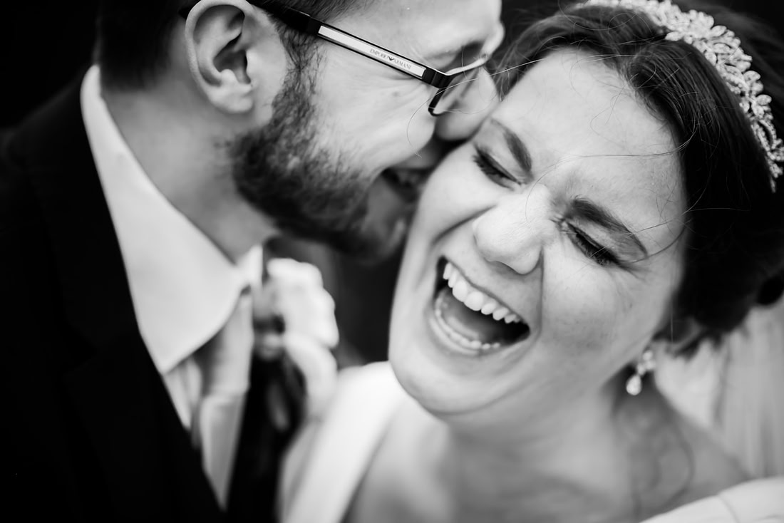 Black and white image of the bride and groom laughing together at a wedding at Mere Brook House.