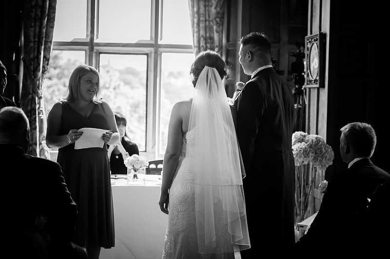 Black and white image of someone doing a reading at a wedding in Chateaux Rhianfa, Anglesey. Wedding Photographer, Celynnen Photography