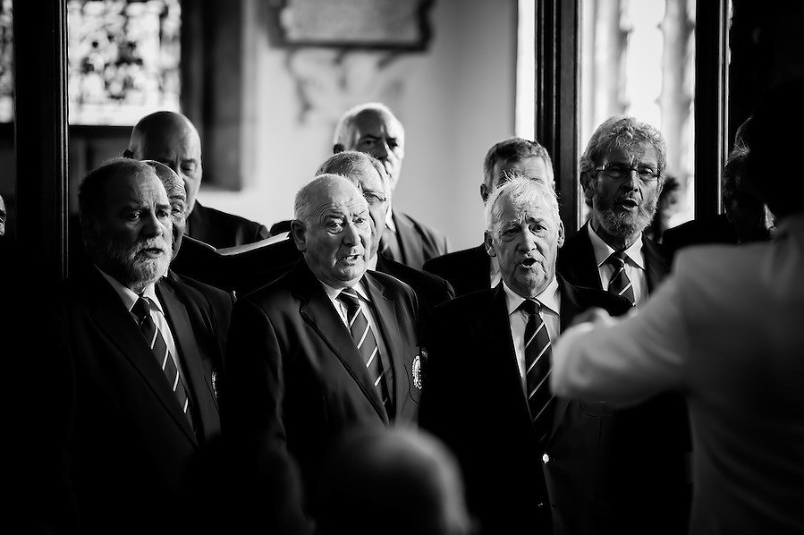 Black and white image of some people singing at a wedding in Chester
