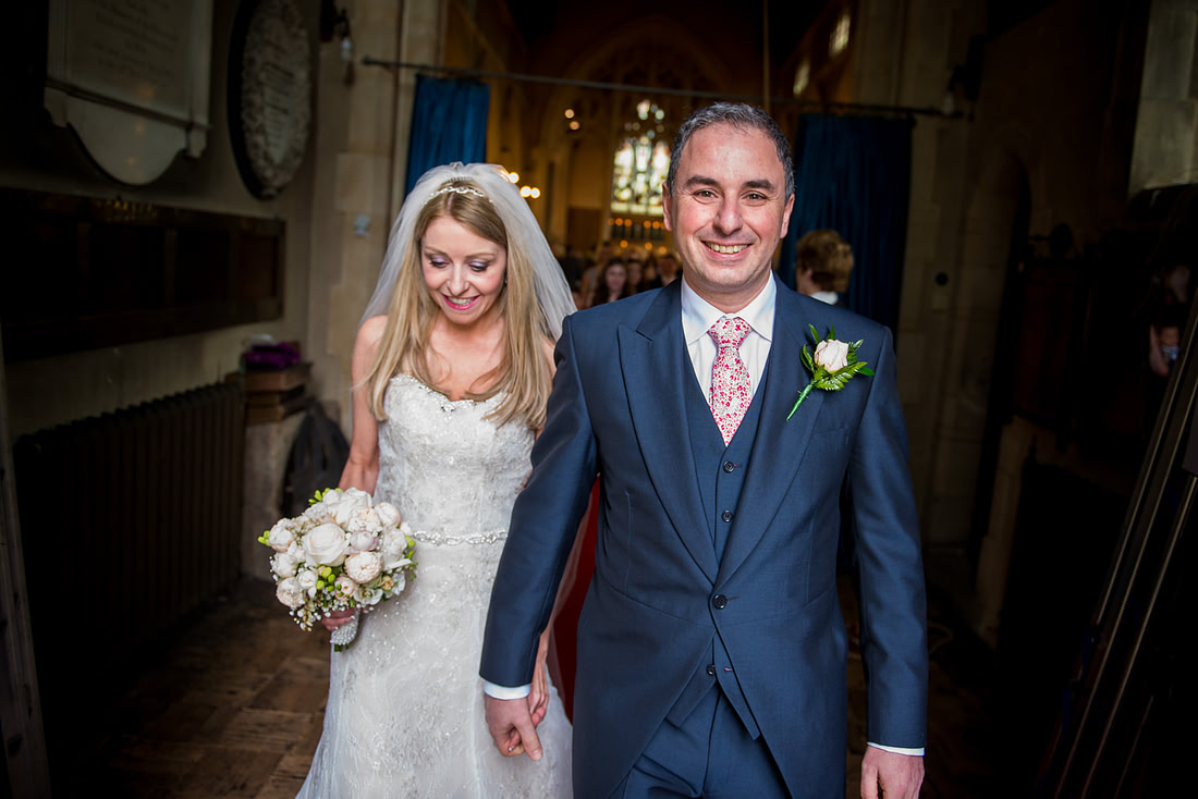 Bride and groom leaving their wedding ceremony as husband and wife in Buckinghamshire.