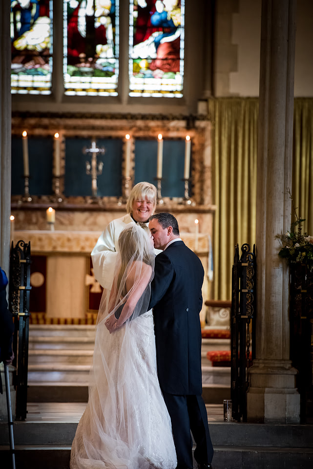 Image of the bride and groom sharing a kiss in a church in Buckinghamshire