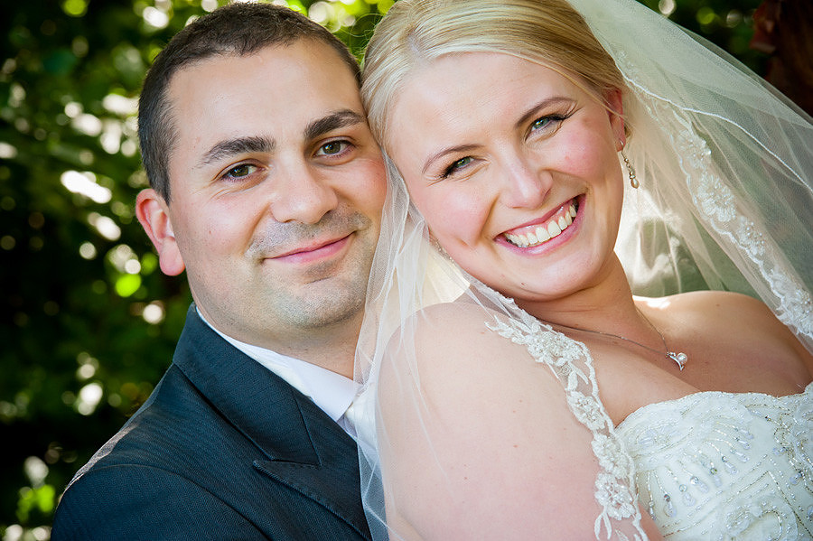 The bride and groom smiling at Seiont Manor, Caernarfon. Wedding photographer: Celynnen Photography