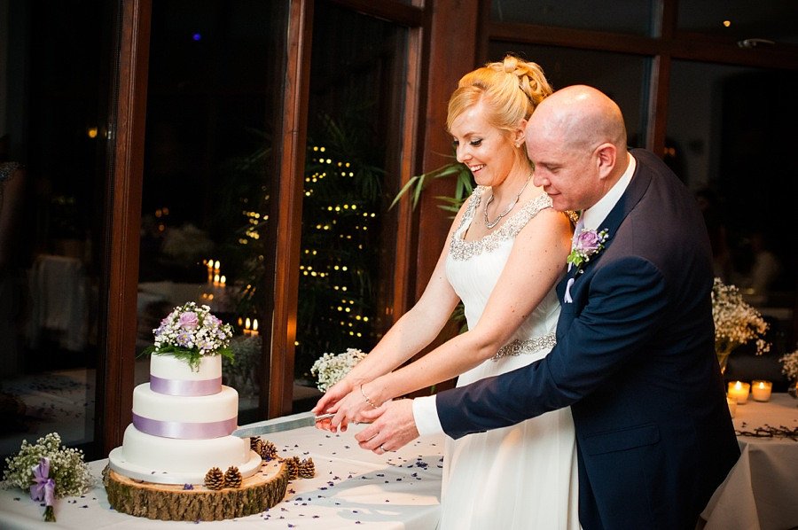 Bride and Groom cutting the cake by North Wales Wedding Photographer Celynnen Photography