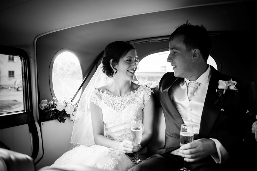 Bride and Groom in the Car with Champagne by North Wales Wedding Photographer Celynnen Photography