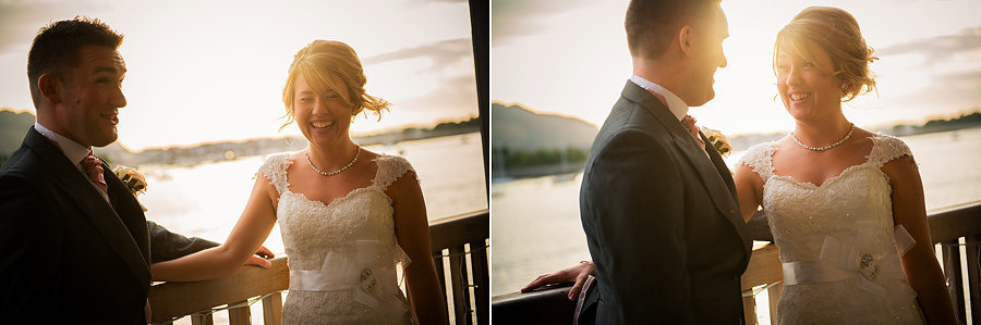 The bride and groom laughing as the sun sets at the Deganwy Quay. Wedding Photographer: Celynnen Photography