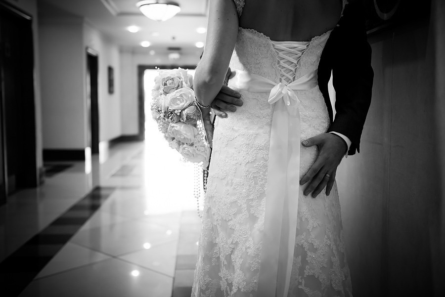 Bride and groom walking after their wedding at the Deganwy Quay. Wedding Photographer: Celynnen Photography