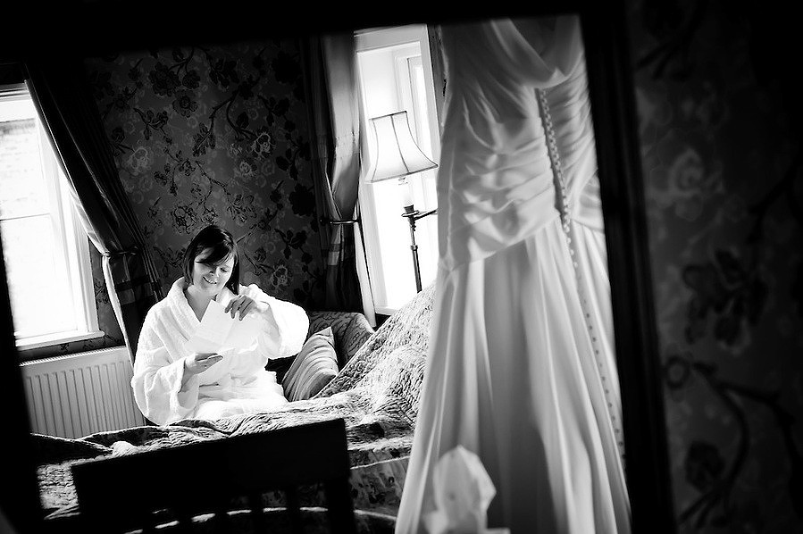 Bride reads a letter from her Groom on the morning of their wedding (Ioan Said / Celynnen Photography)