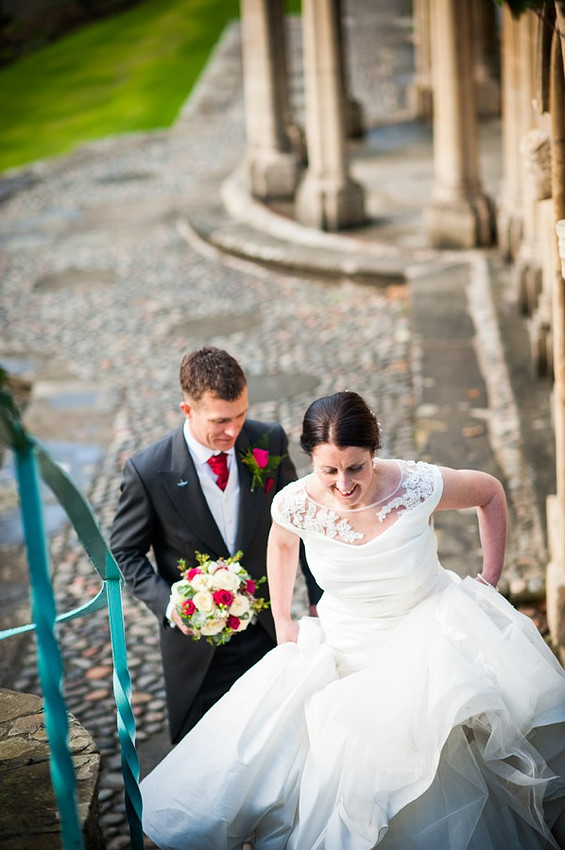 Bride and Groom walking up steps by Wedding Photographer Celynnen Photography
