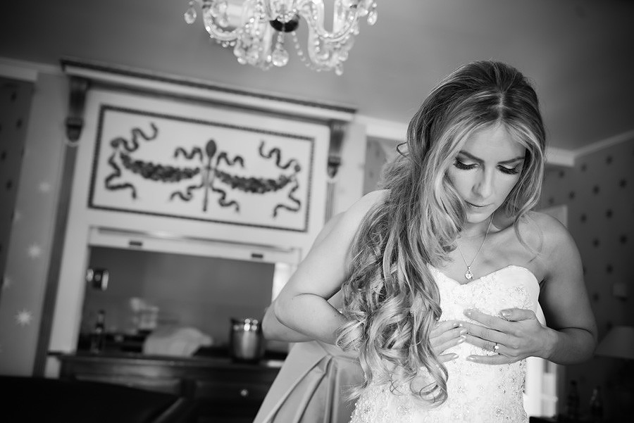 Bride adjusting her dress before her wedding in Portmeirion
