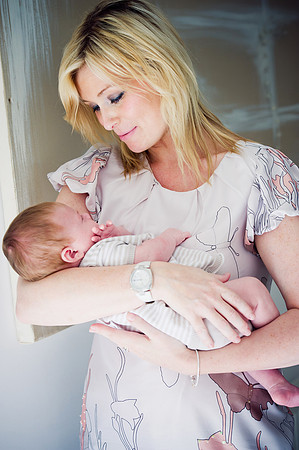 Portrait of a mother with her newborn baby from a bump to baby photoshoot