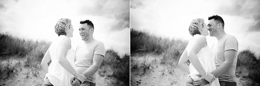 Couple play fighting on the sand dunes in talacre beach for their portrait session near mold in North wales