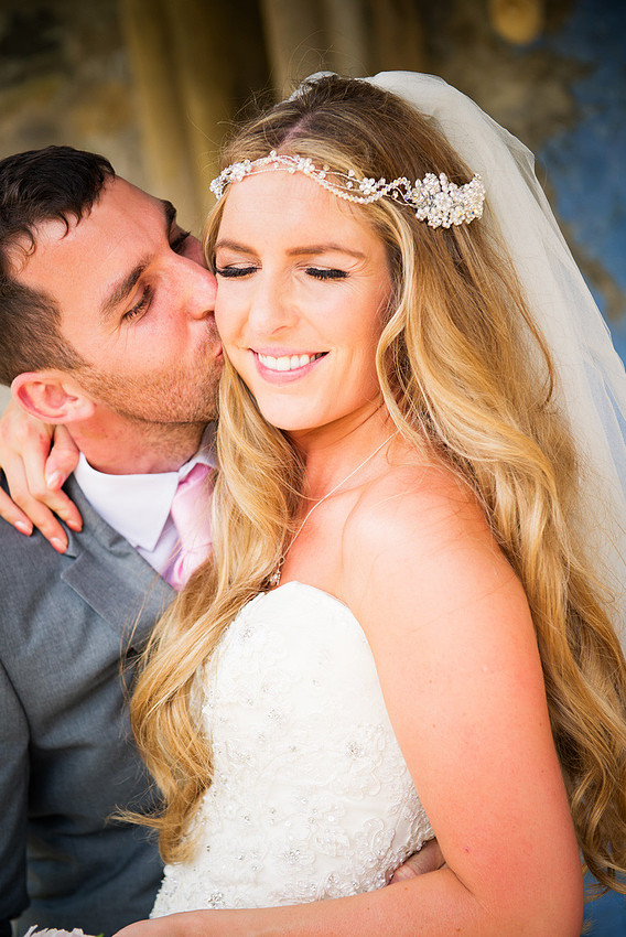 Groom kissing his bride after ther wedding in Portmeirion. Wedding photographer: Celynnen Photography