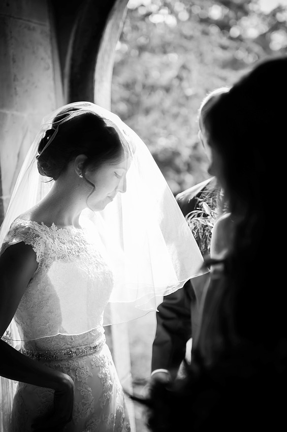 Bride in Doorway of Church with her Veil Down by North Wales Wedding Photographer Celynnen Photography