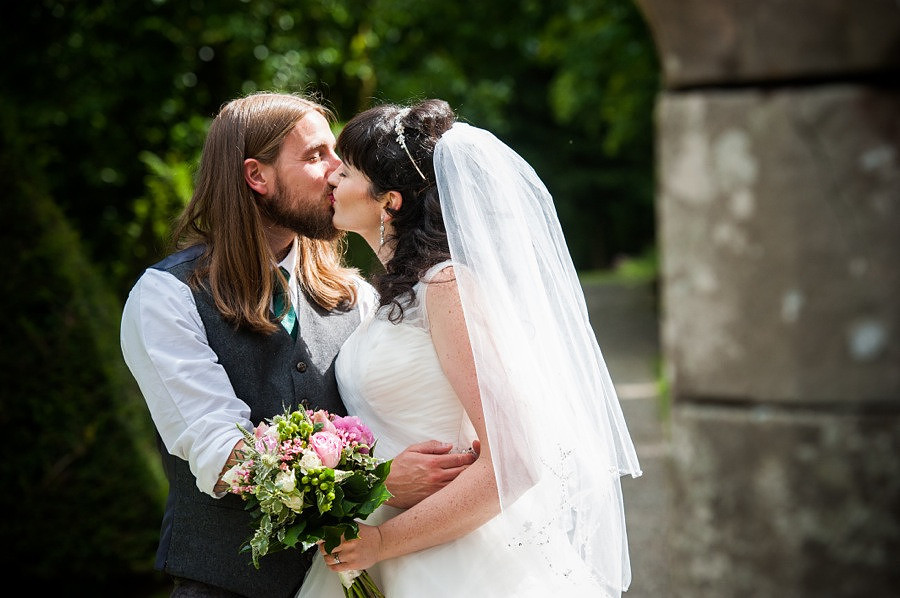 Bride and groom kissing on their wedding day at Gwydir Castle, by Celynnen Photography