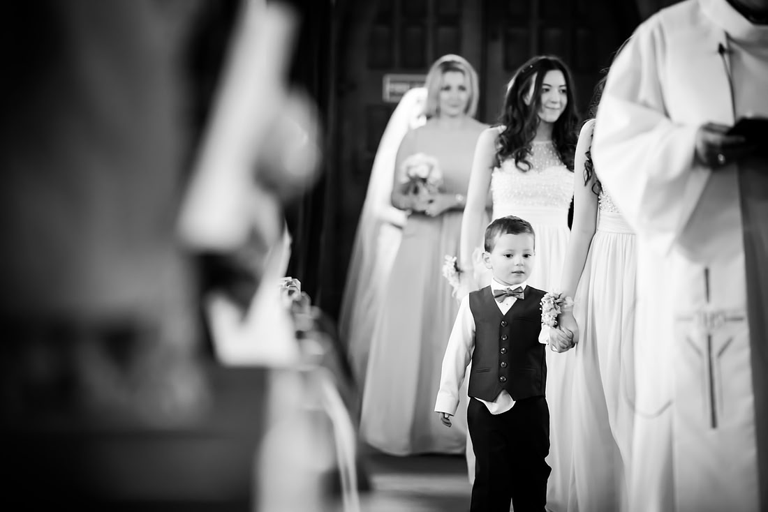 Black and white image of the bridal party walking down the aisle at a wedding in Buckinghamshire.
