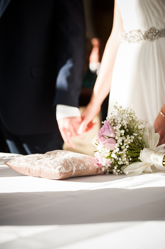Bride and Groom holding hands at altar by North Wales Wedding Photographer Celynnen Photography