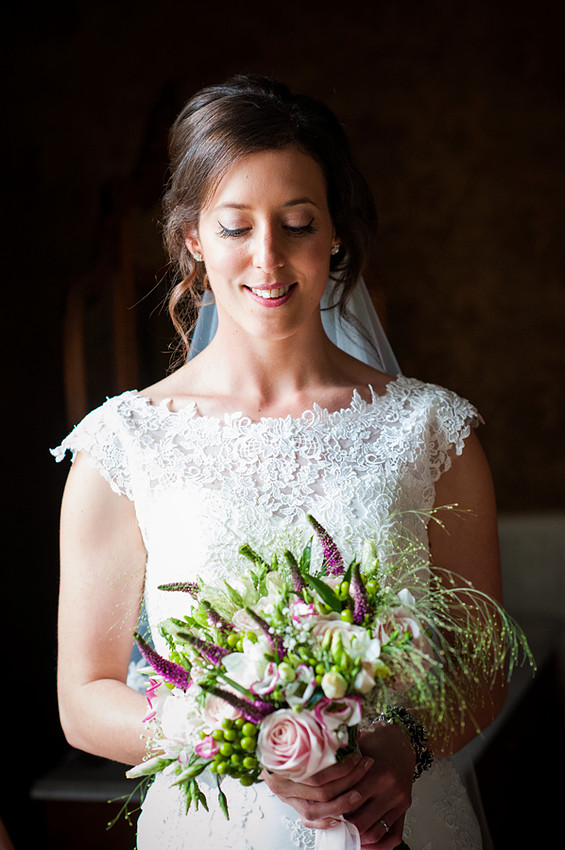 Smiling Bride Holding Flowers by North Wales Wedding Photographer Celynnen Photography