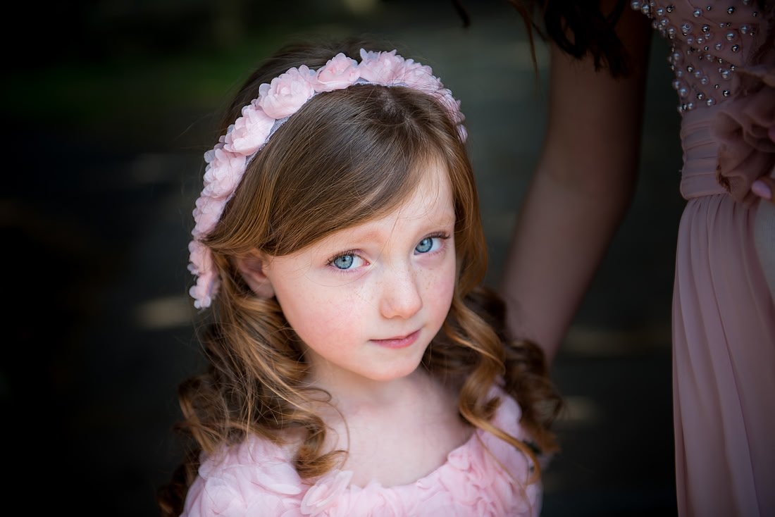 Portrait of a flower girl at a wedding in Buckinghamshire.